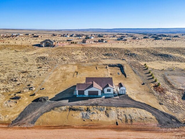 drone / aerial view with view of desert and a rural view