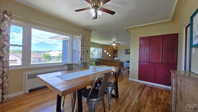 316 N Hooper Ave, Walsenburg, CO 81089 - dining area featuring radiator heating unit, ceiling fan, and light wood-style floors