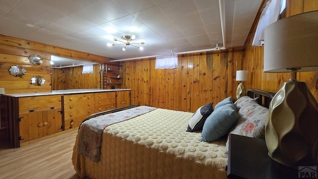 316 N Hooper Ave, Walsenburg, CO 81089 - bedroom with light wood-style floors and wooden walls