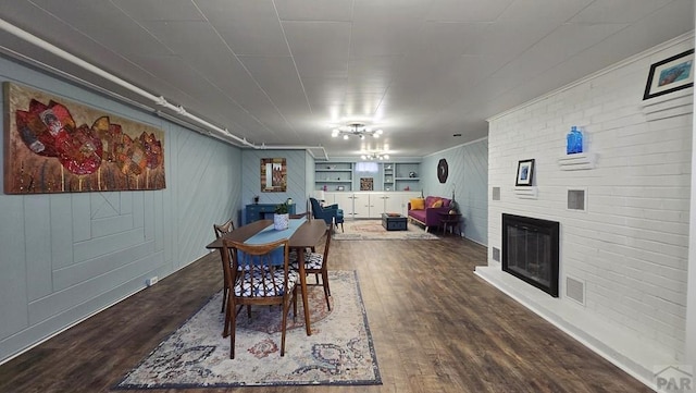 316 N Hooper Ave, Walsenburg, CO 81089 - dining room featuring wood finished floors, a fireplace, and built in shelves