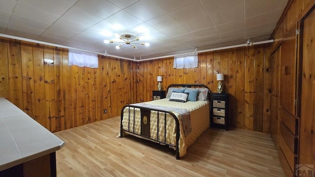 316 N Hooper Ave, Walsenburg, CO 81089 - bedroom featuring wood finished floors and wooden walls