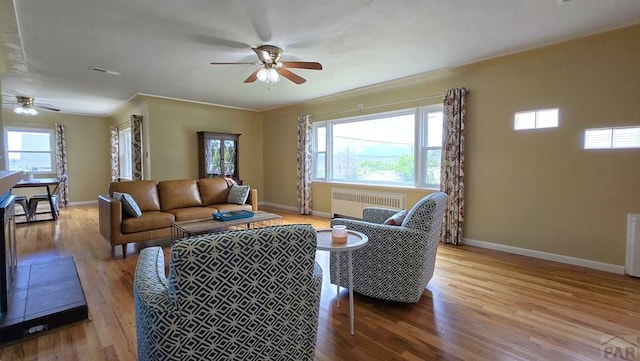 316 N Hooper Ave, Walsenburg, CO 81089 - living area featuring radiator heating unit, ceiling fan, and wood finished floors