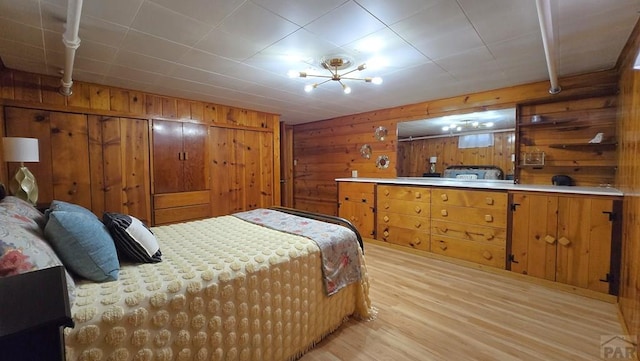 316 N Hooper Ave, Walsenburg, CO 81089 - bedroom with light wood-style flooring and wooden walls