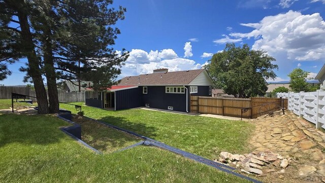 316 N Hooper Ave, Walsenburg, CO 81089 - rear view of house with a fenced backyard
