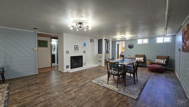 316 N Hooper Ave, Walsenburg, CO 81089 - dining room with wood finished floors, a fireplace, wood walls, and a chandelier