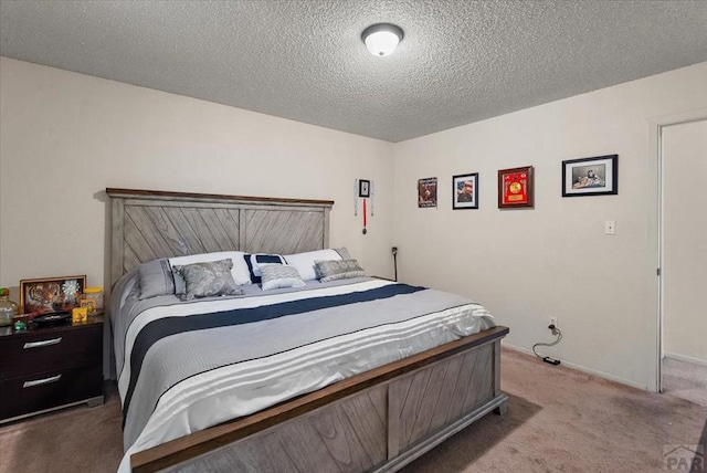 carpeted bedroom featuring a textured ceiling