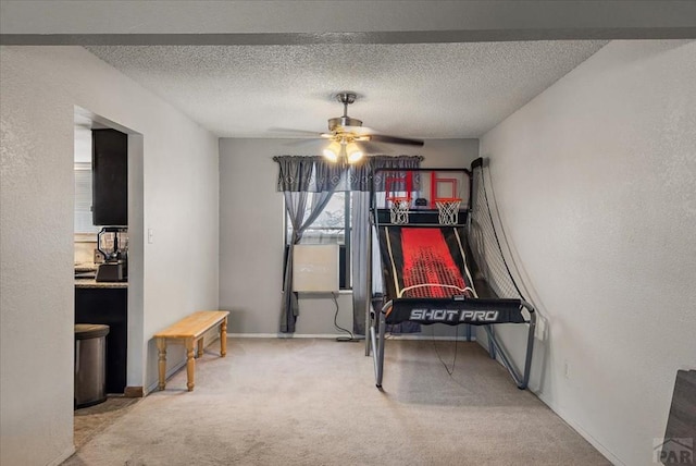 carpeted bedroom with a ceiling fan, a textured wall, and a textured ceiling