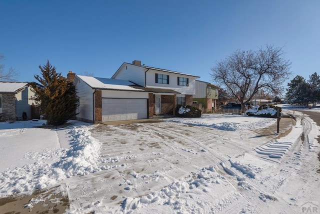 view of front of home featuring a garage, brick siding, and fence