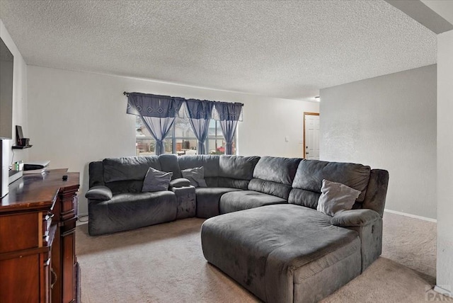 living area with carpet, baseboards, and a textured ceiling