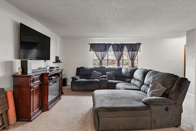 living room featuring light carpet, a fireplace, and a textured ceiling