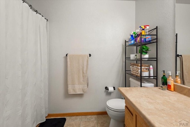 full bath featuring tile patterned flooring, toilet, vanity, and baseboards