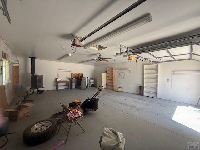 304 S Mullen, Lamar, CO 81052 - garage with a garage door opener and a wood stove