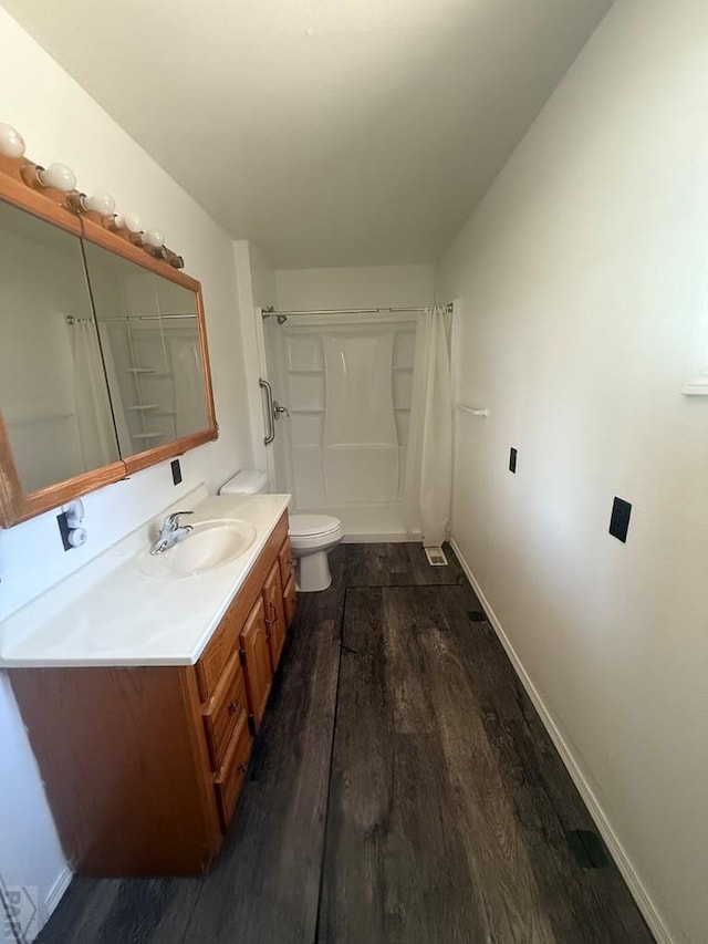 304 S Mullen, Lamar, CO 81052 - full bathroom featuring vanity and wood finished floors