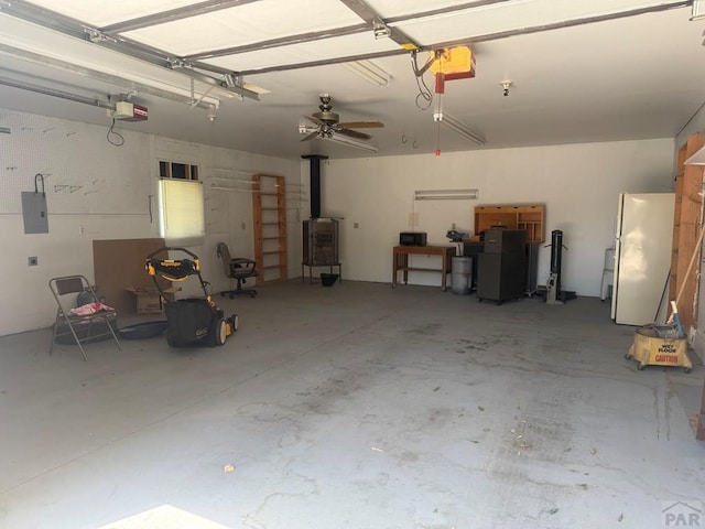 304 S Mullen, Lamar, CO 81052 - garage with freestanding refrigerator, a garage door opener, and electric panel
