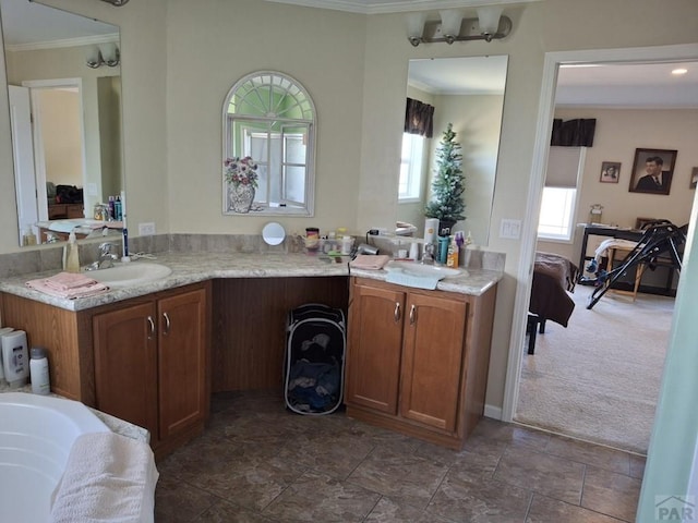 ensuite bathroom with ornamental molding, vanity, and ensuite bath