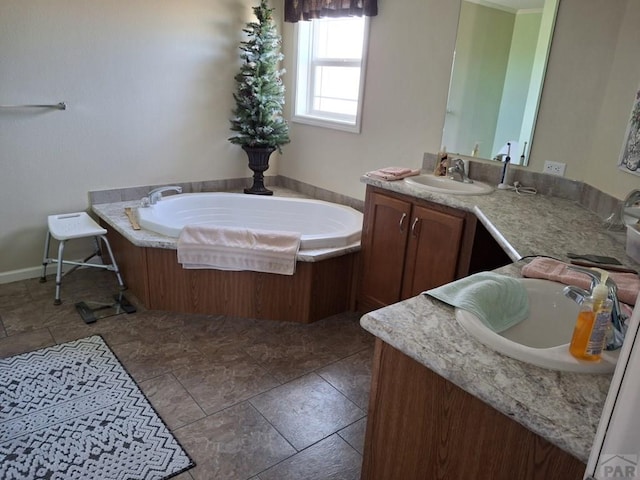 bathroom with a garden tub, baseboards, and vanity