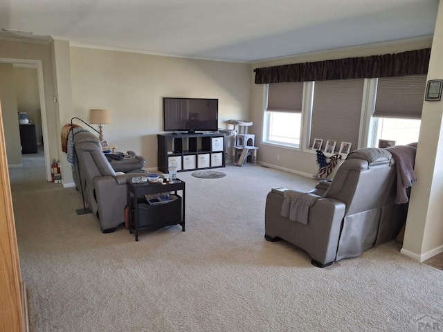 living area with light carpet, visible vents, baseboards, and crown molding