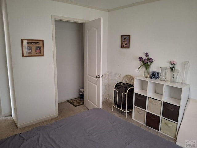 bedroom featuring light carpet and baseboards