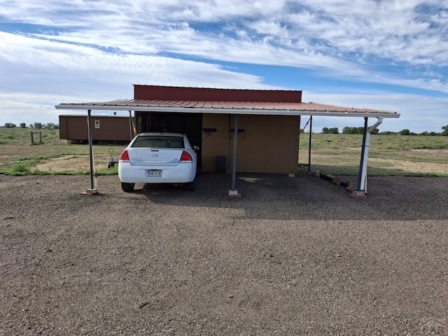 view of parking with a rural view