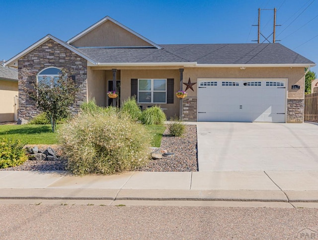 view of front of home with a garage, stone siding, driveway, and stucco siding