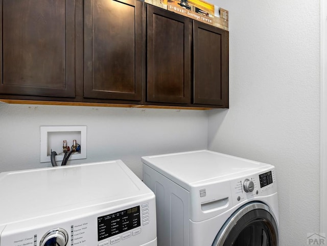 laundry area with cabinet space and separate washer and dryer