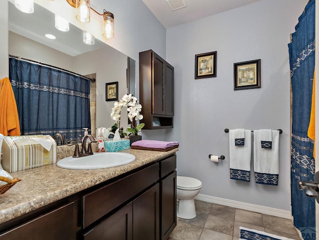 bathroom featuring visible vents, baseboards, toilet, tile patterned floors, and vanity