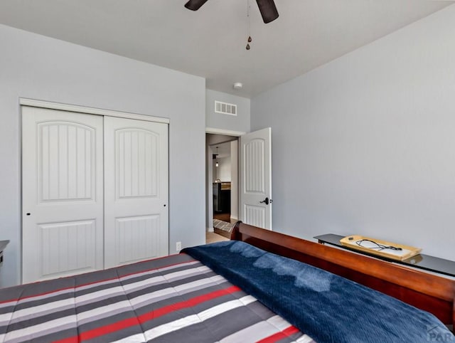 bedroom featuring a ceiling fan, a closet, and visible vents