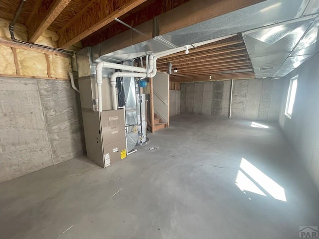 basement with gas water heater and heating unit