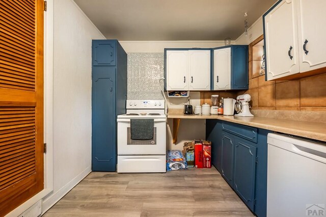 kitchen with light wood-style flooring, white appliances, white cabinetry, light countertops, and decorative backsplash