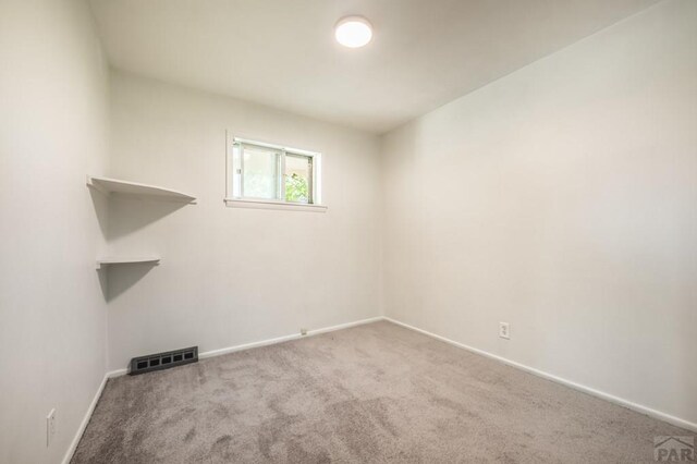 unfurnished room featuring light carpet, baseboards, and visible vents