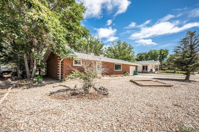 back of property with a chimney