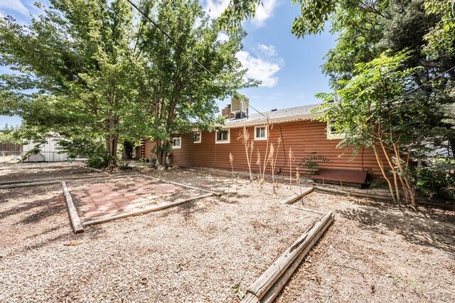 view of home's exterior with fence and a patio