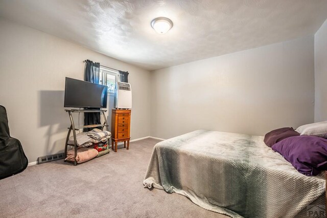 carpeted bedroom with visible vents and baseboards