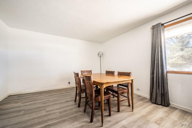 dining area featuring wood finished floors and baseboards