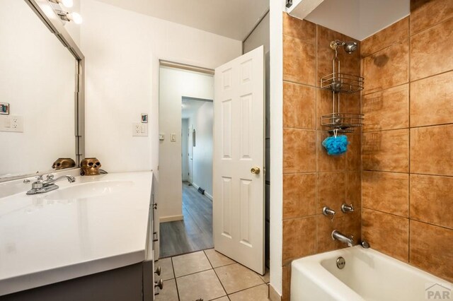 full bathroom featuring  shower combination, tile patterned flooring, and vanity