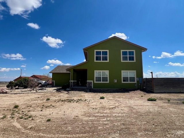 1507 N Gentry Ln, Pueblo West, CO 81007 - rear view of house featuring stucco siding and fence