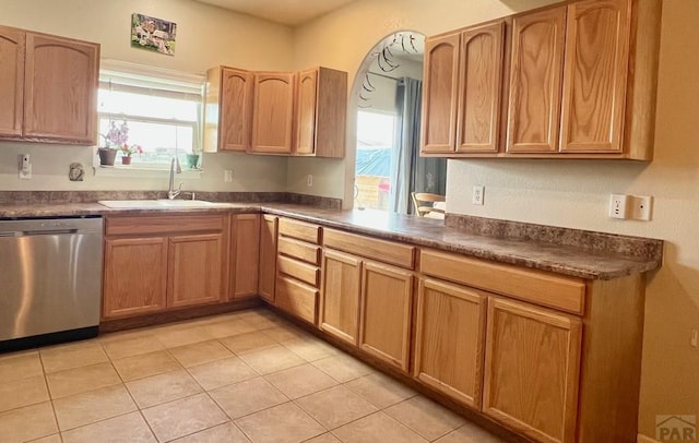 1507 N Gentry Ln, Pueblo West, CO 81007 - kitchen with dishwasher, a sink, dark countertops, and light tile patterned floors