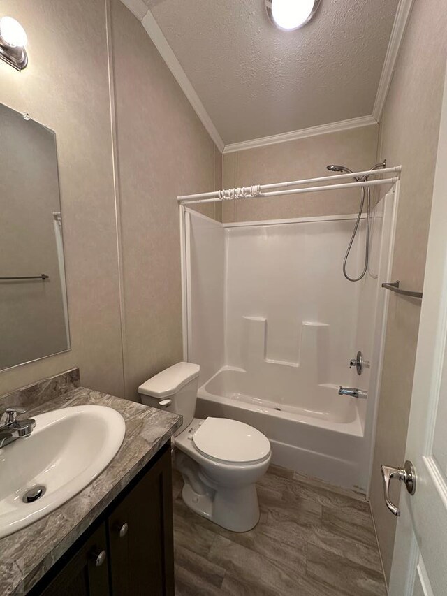 bathroom with shower / bathtub combination, a textured ceiling, wood finished floors, vanity, and crown molding