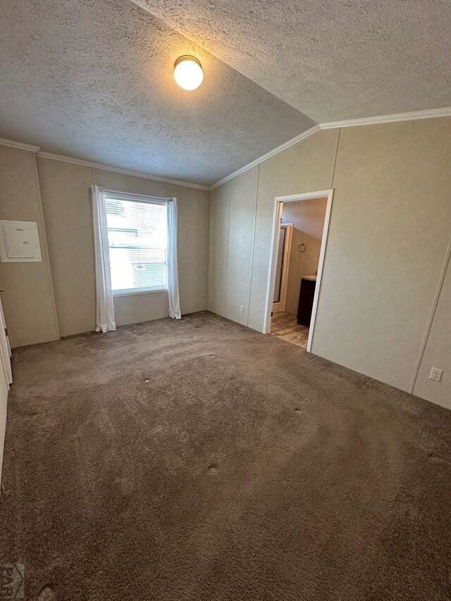 unfurnished bedroom with light carpet, connected bathroom, ornamental molding, vaulted ceiling, and a textured ceiling