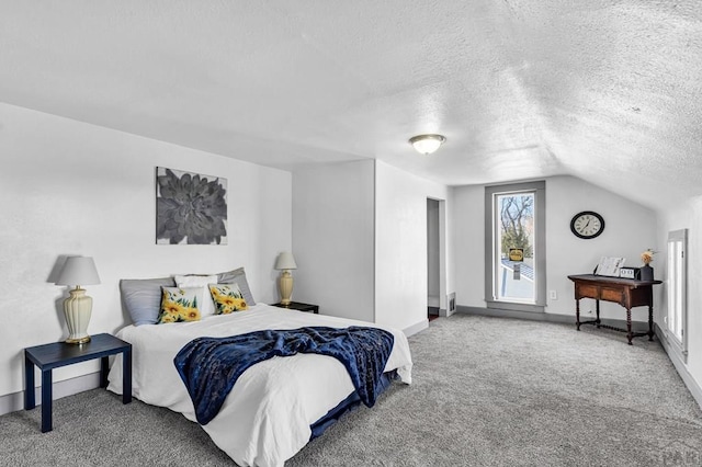carpeted bedroom with a textured ceiling, vaulted ceiling, and baseboards