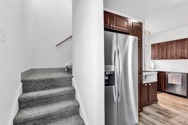 stairs with baseboards and wood finished floors