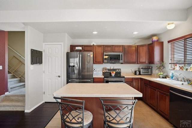 5073 Buchanan Dr, Pueblo, CO 81008 - kitchen with stainless steel appliances, light countertops, a breakfast bar, a kitchen island, and recessed lighting