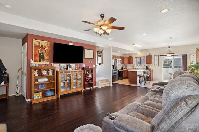 5073 Buchanan Dr, Pueblo, CO 81008 - living area featuring wood finished floors, ceiling fan, and recessed lighting