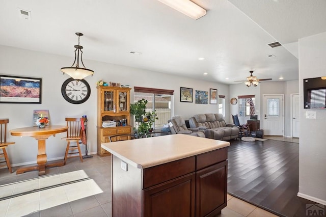 5073 Buchanan Dr, Pueblo, CO 81008 - kitchen featuring light tile patterned floors, light countertops, ceiling fan, recessed lighting, and a center island