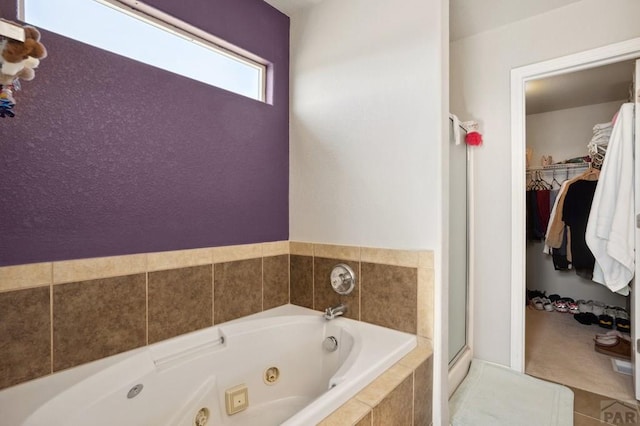5073 Buchanan Dr, Pueblo, CO 81008 - full bath featuring a tub with jets, a stall shower, and a spacious closet