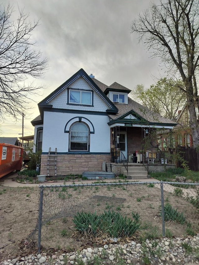 1017 Lake Ave, Pueblo, CO 81004 - bungalow with stone siding, a porch, and fence