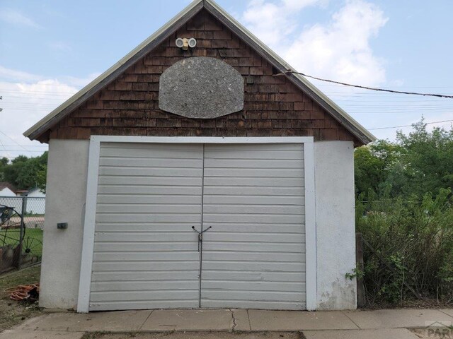 view of outbuilding featuring an outdoor structure and fence