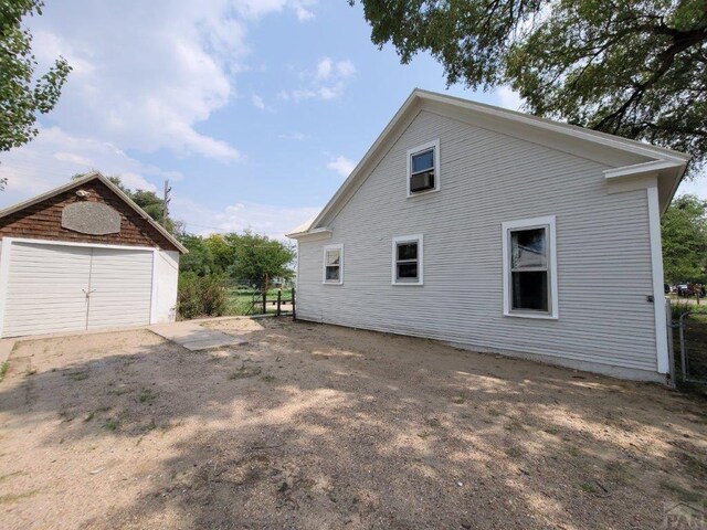 view of home's exterior with an outbuilding and a detached garage