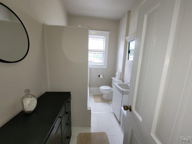 bathroom featuring toilet, tile patterned flooring, and vanity