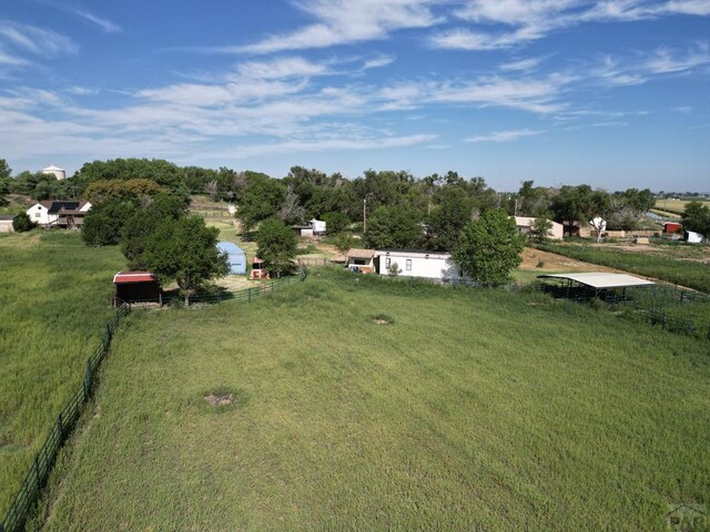 view of yard with a rural view and fence